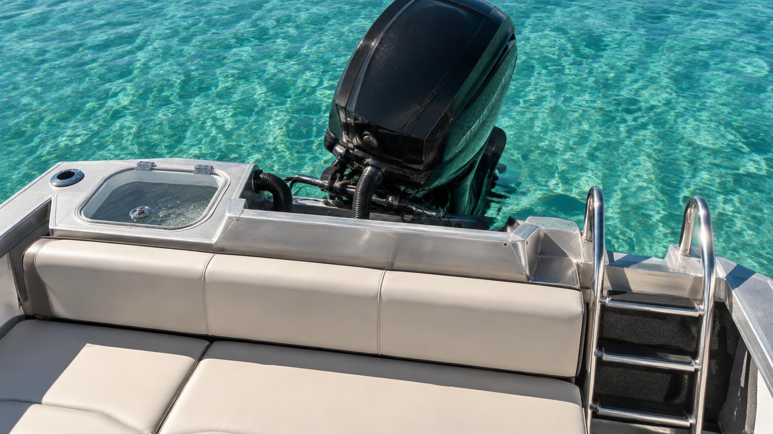Stern of an aluminium Bowrider Amazing Photo by www.BOWRIDER-BOATS.com — Stern of an aluminium bowrider showing the convertible rear lounge, live bait tank, boarding ladder and four-stroke outboard. Images Created by www.Bowrider-Boats.com