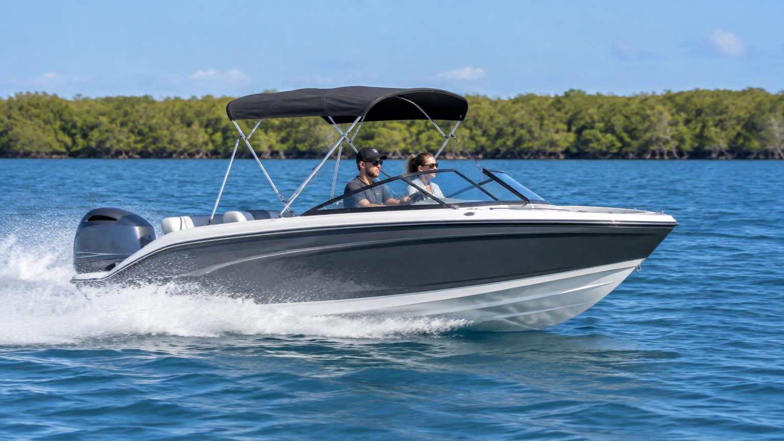 Bowrider Boat Amazing Photo by www.BOWRIDER-BOATS.com — Charcoal grey and white 5.2 metre aluminium bowrider running at speed across light chop with the bimini up and spray thrown clear of the cockpit interior seating. Images Created by www.Bowrider-Boats.com