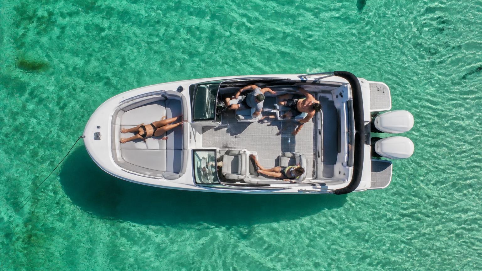 Sea Ray SDX 250 bowrider boat, aerial view anchored over clear water, 25.4 ft fibreglass hull with outboard propulsion. Images and Photos created by www.bowrider-boats.com