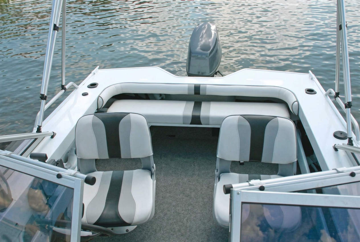 Aluminium Bowrider Amazing Photo by www.BOWRIDER-BOATS.com — Aluminium Bowrider cockpit interior seating Seating Layout Amazing Photo by www.BOWRIDER-BOATS.com — Interior view through the wraparound windscreen of twin grey and white upholstered swivel seats with an outboard beyond the transom. Images Created by www.Bowrider-Boats.com. Images Created by www.Bowrider-Boats.com