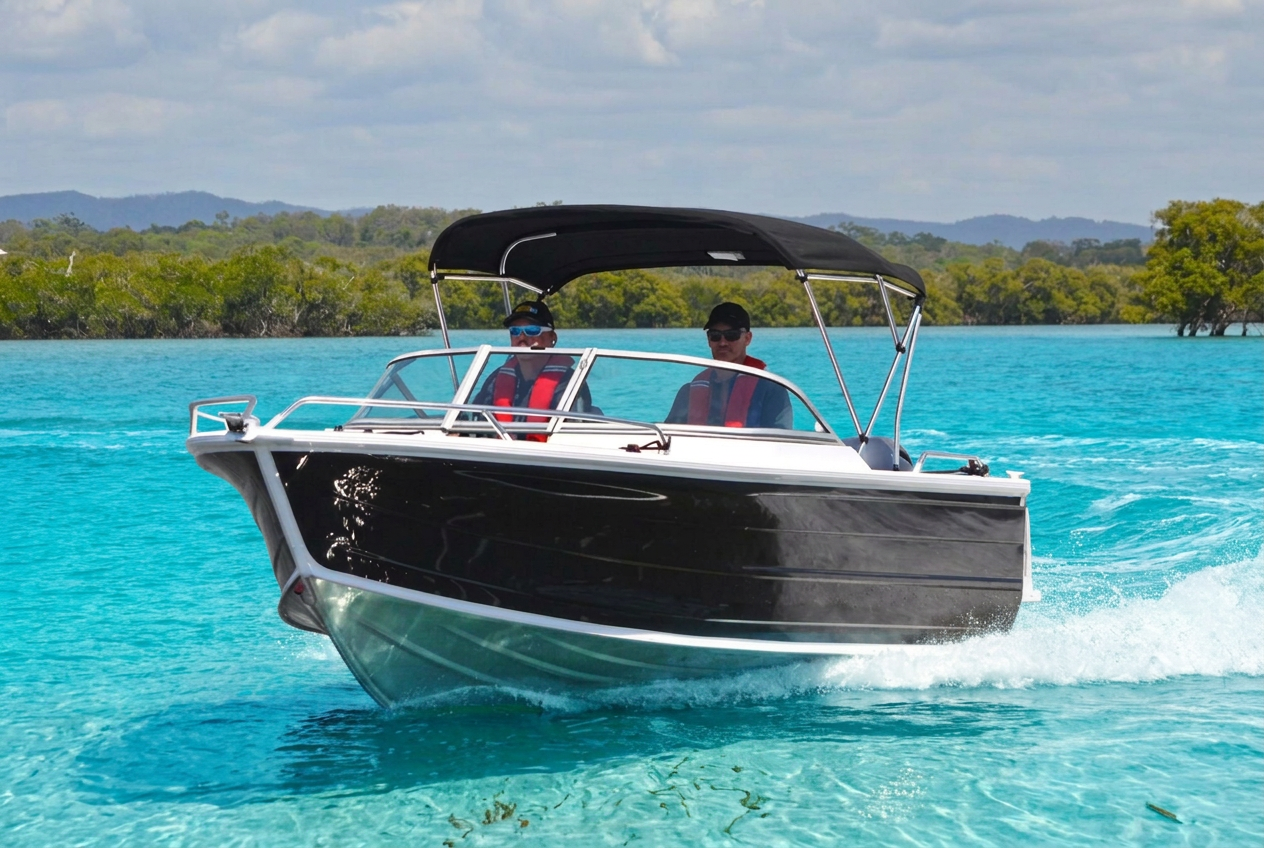Dark Blue Aluminium Bowrider Amazing Photo by www.BOWRIDER-BOATS.com — Dark Blue Aluminium Bowrider Running Crystal Blue Water Amazing Photo by www.BOWRIDER-BOATS.com — front bow and side view of a dark blue aluminium bowrider with bare silver lower hull and fine Blade-style entry slicing through crystal-clear turquoise water with passengers aboard. Images Created by www.Bowrider-Boats.com. Images Created by www.Bowrider-Boats.com